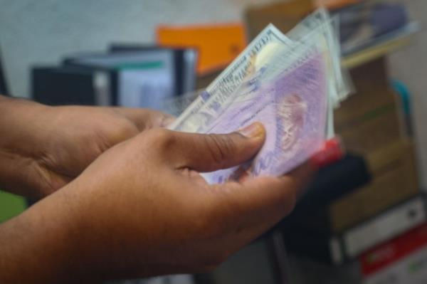 Ringgit ends firmer vs US dollar